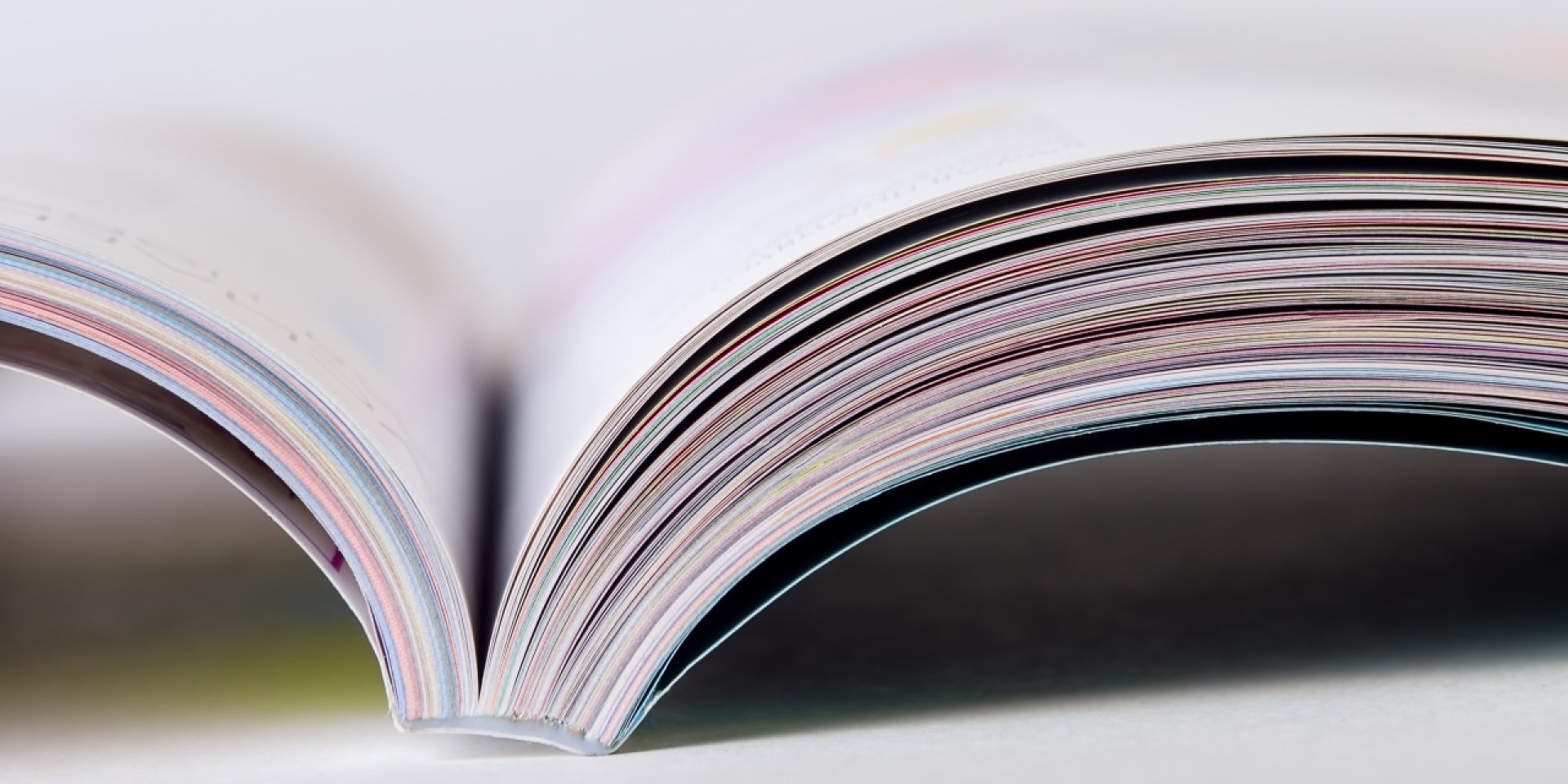 Colorful pages of an open magazine, close up. Selective focus.